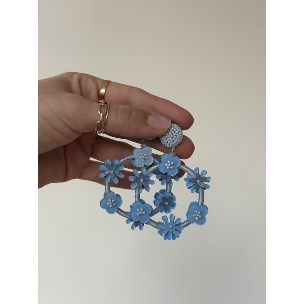 Statement light blue floral hoop earrings with layered daisy details and beaded